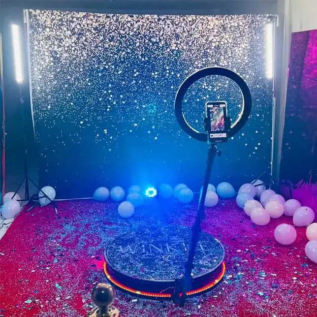 Confetti backdrop with a 360 photo booth platform at a Goa event