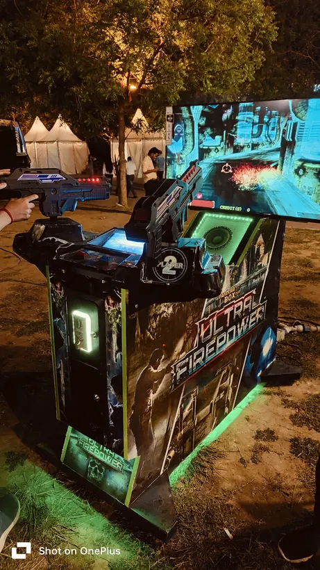 Alien shooter arcade machine set up at a night event in Goa