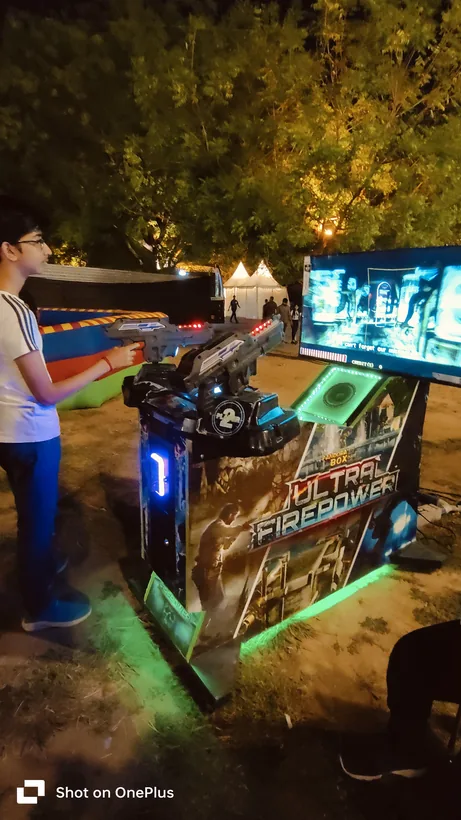 Guest playing the alien shooter arcade game during a Goa celebration