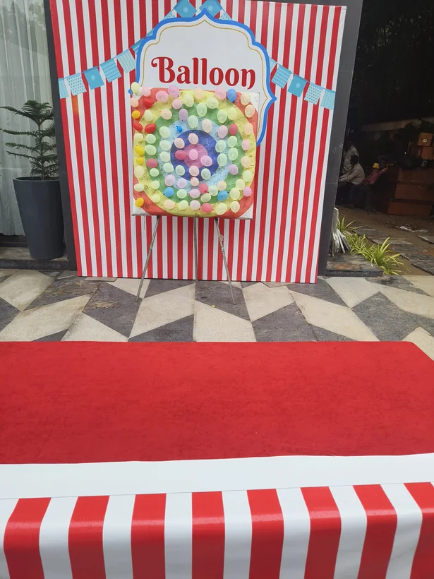 Balloon shooting game with striped event backdrop prepared in Goa