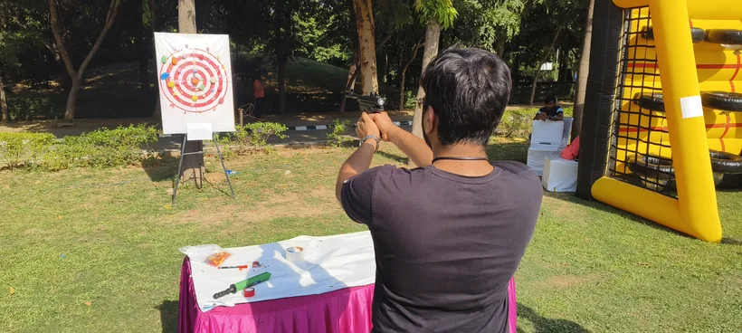 Outdoor balloon shooting activity set up for a celebration in Goa