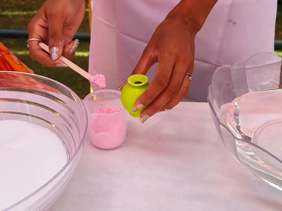 Participant filling a mould during the Bath Bomb workshop