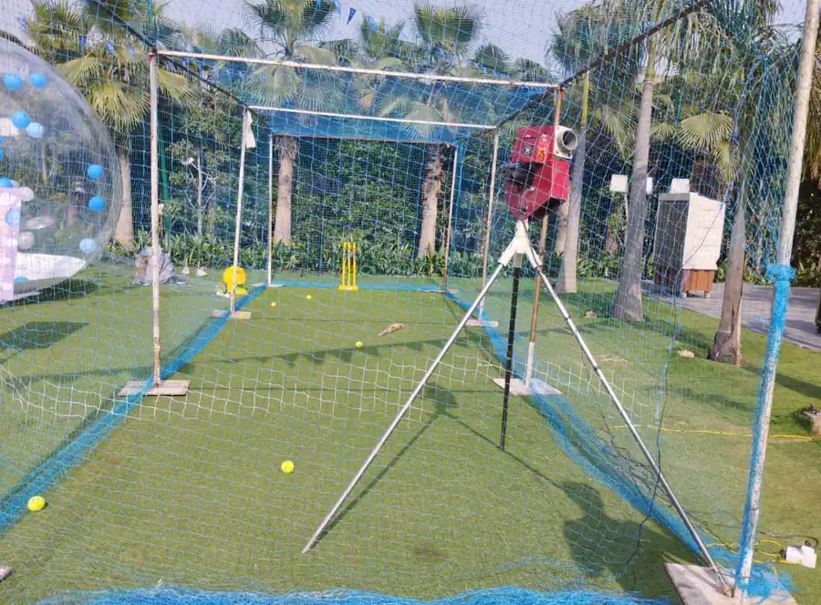 Guests enjoying cricket bowling machine during a Goa celebration