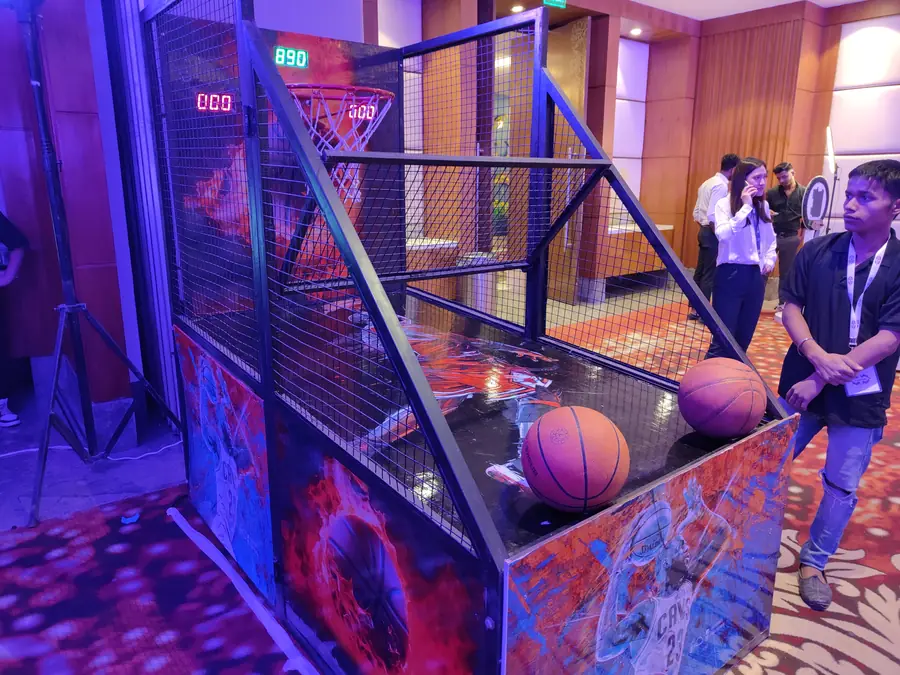 Guests enjoying electronic basketball game during a Goa celebration