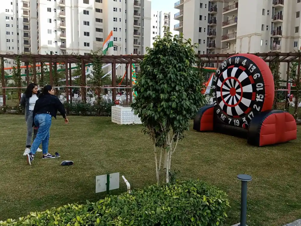 Guests enjoying the Foot Dart game at an outdoor event in Noida