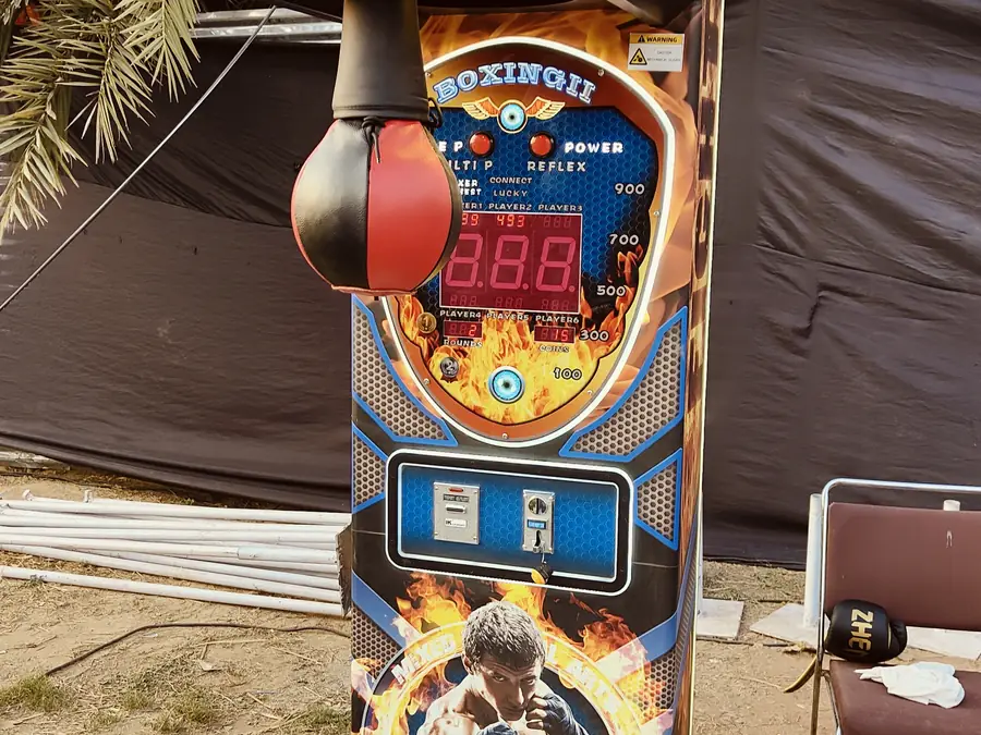 Guests enjoying power punch arcade game during a Goa celebration